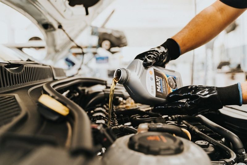 Fresh oil going into an engine during a service.