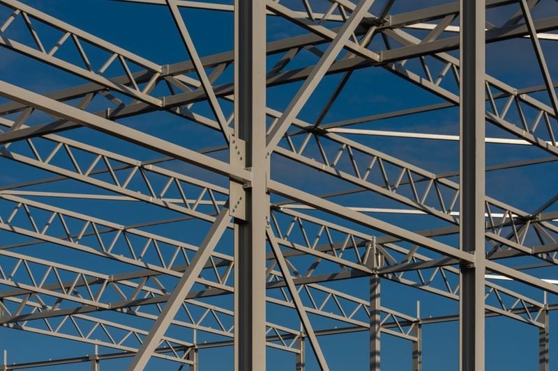 Steel framework against a clear sky.